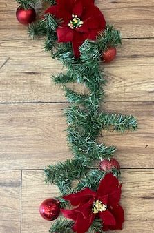 Christmas Garland with Poinsettia flowers and red christmas balls on Sale